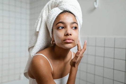 Woman in bathroom conducting self-care routine after taking an everything shower.