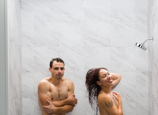 Couple showering together without a tandem shower so one person is freezing in the corner.