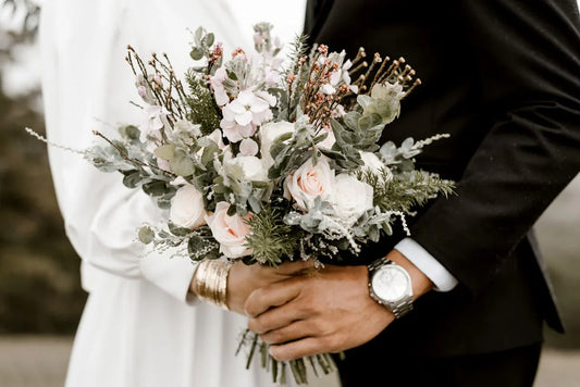 Photo for wedding registry featuring a couple in wedding attire holding a flower bouquet.