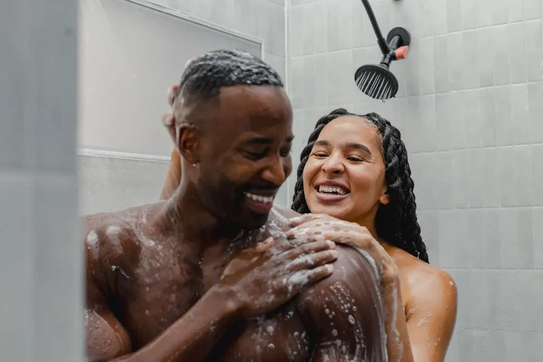 Couple showering together and connecting through non-sexual intimacy.